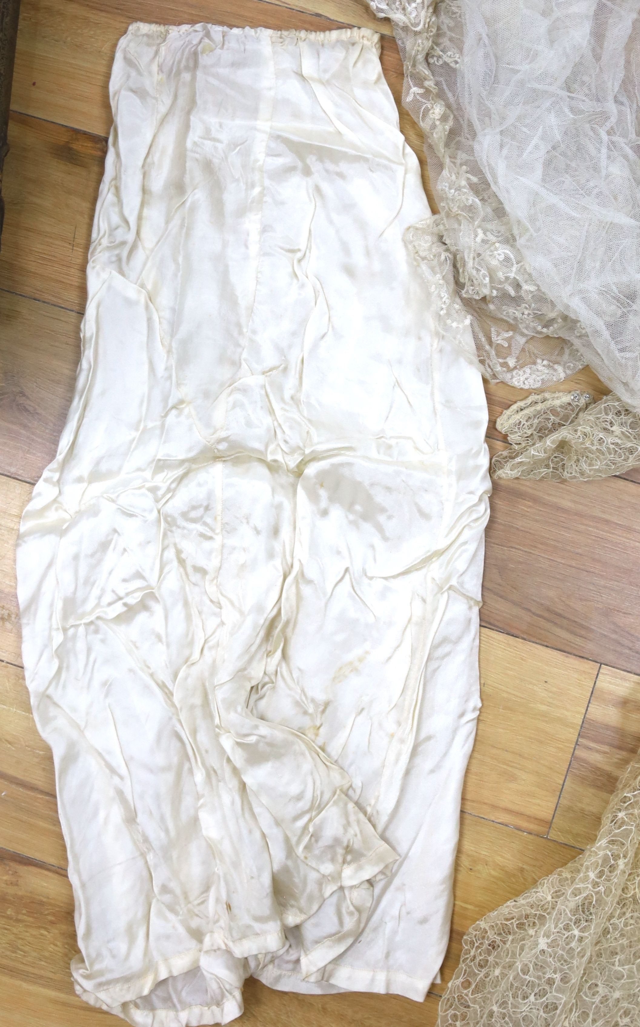 A 1930's lace and satin wedding dress including net veil